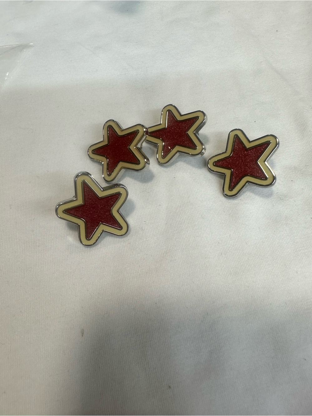 Coach PINTRILL x COACH Enamel Pin and four stars.